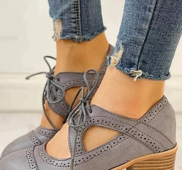 Gray Women’s PU Leather Brogue Heeled Boots on the model