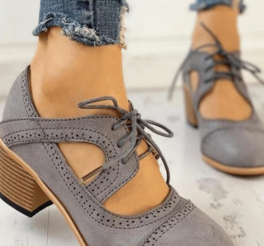 Gray Women’s PU Leather Brogue Heeled Boots on the model