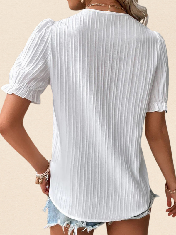 White Women’s Puff Sleeve V-Neck Blouse on the model