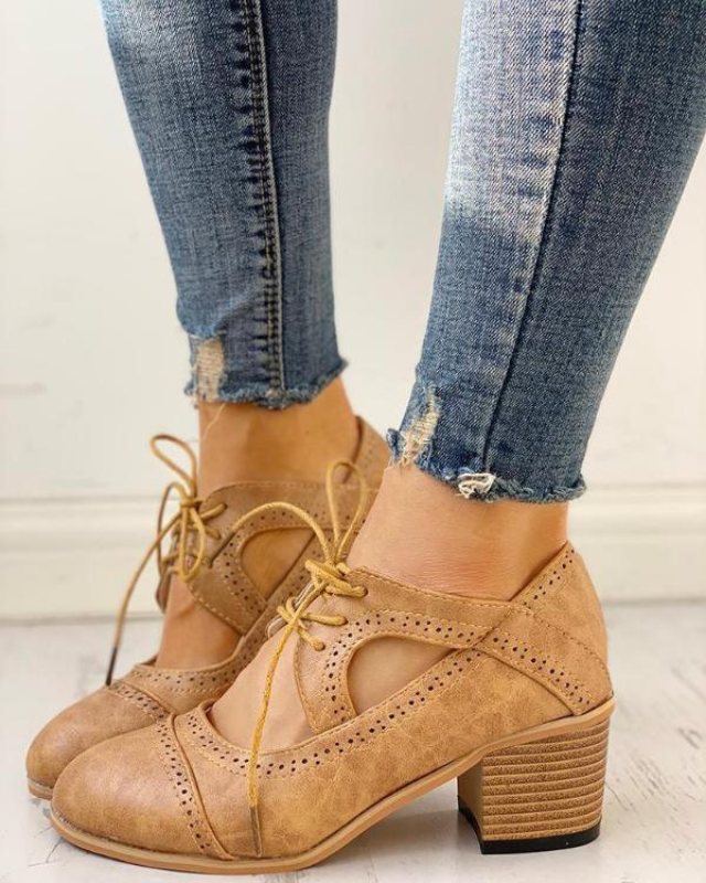 Beige Women’s PU Leather Brogue Heeled Boots on the model