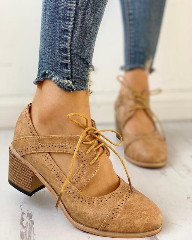 Beige Women’s PU Leather Brogue Heeled Boots on the model