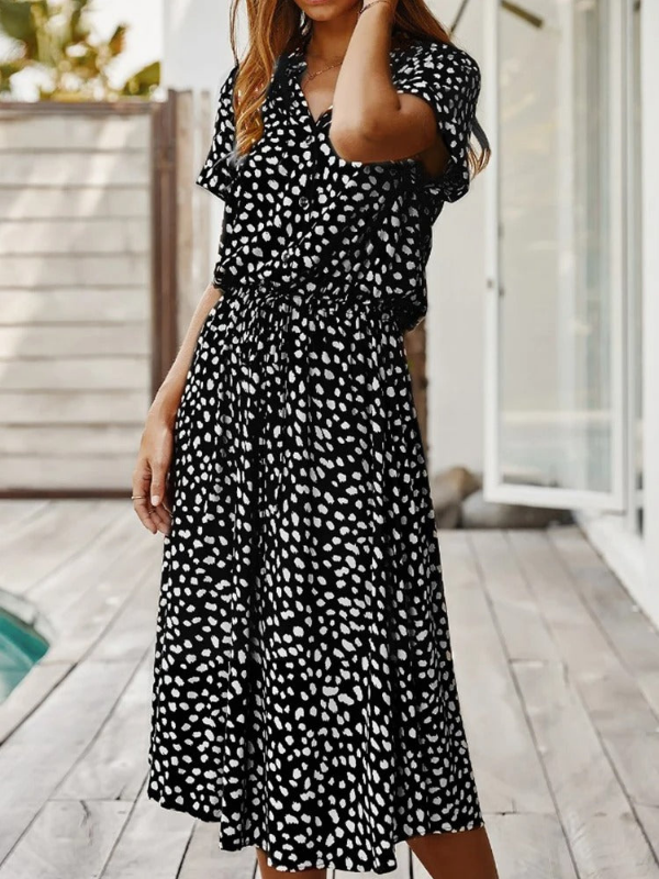 Black Women’s Breezy Printed Midi Summer Dress with Short Sleeves on the model