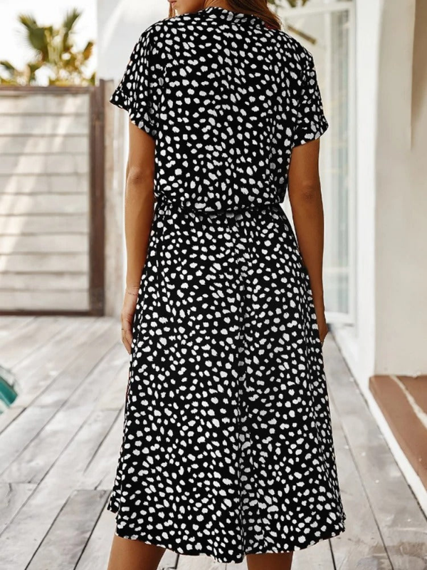 Black Women’s Breezy Printed Midi Summer Dress with Short Sleeves on the model