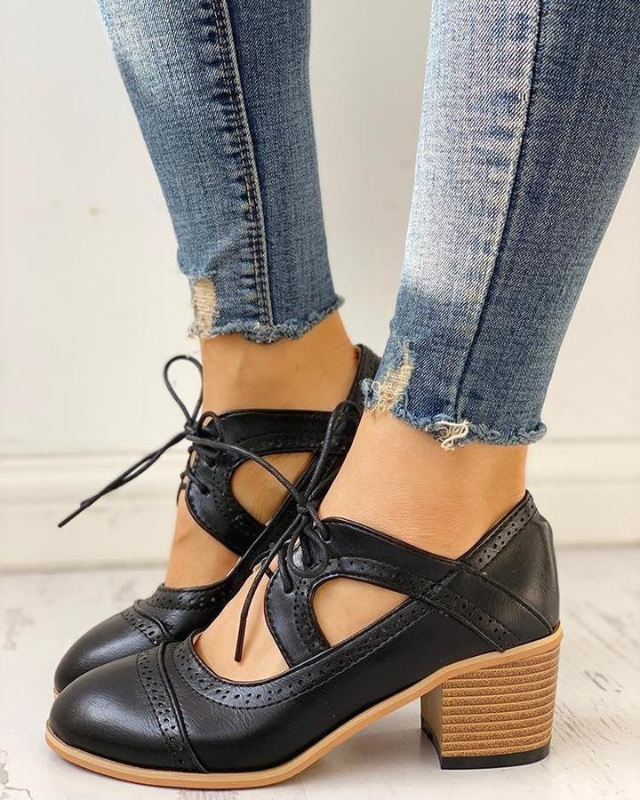 Black Women’s PU Leather Brogue Heeled Boots on the model