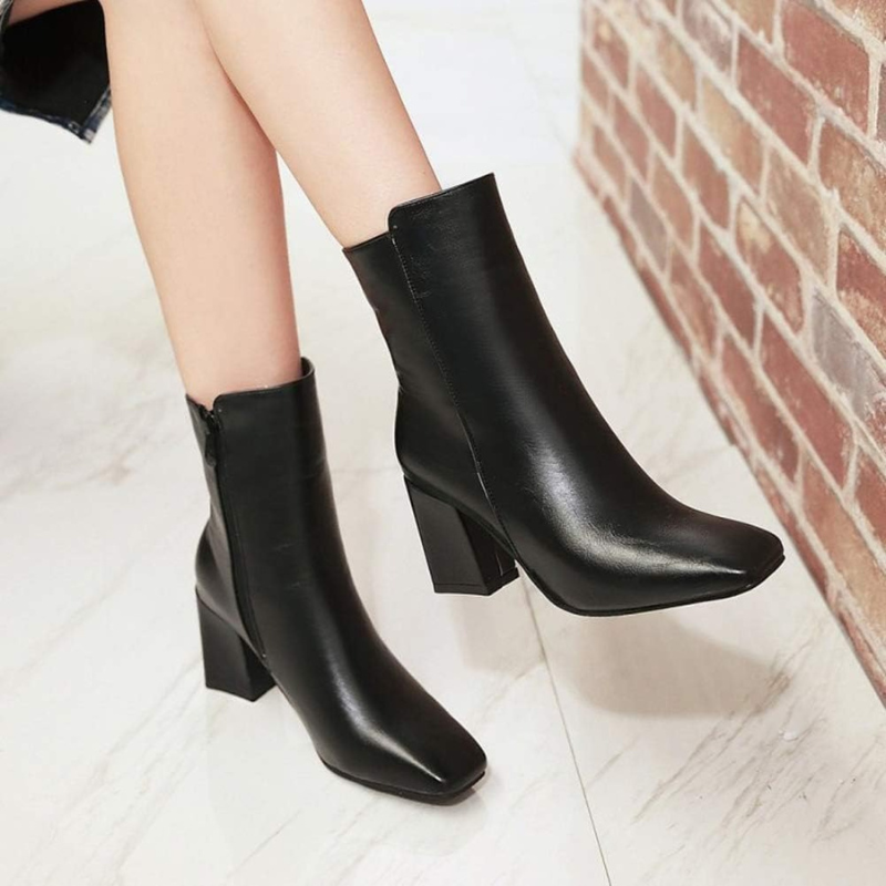 Black Women’s Sleek Side-Zip Ankle Boots with Comfortable Heel on the model