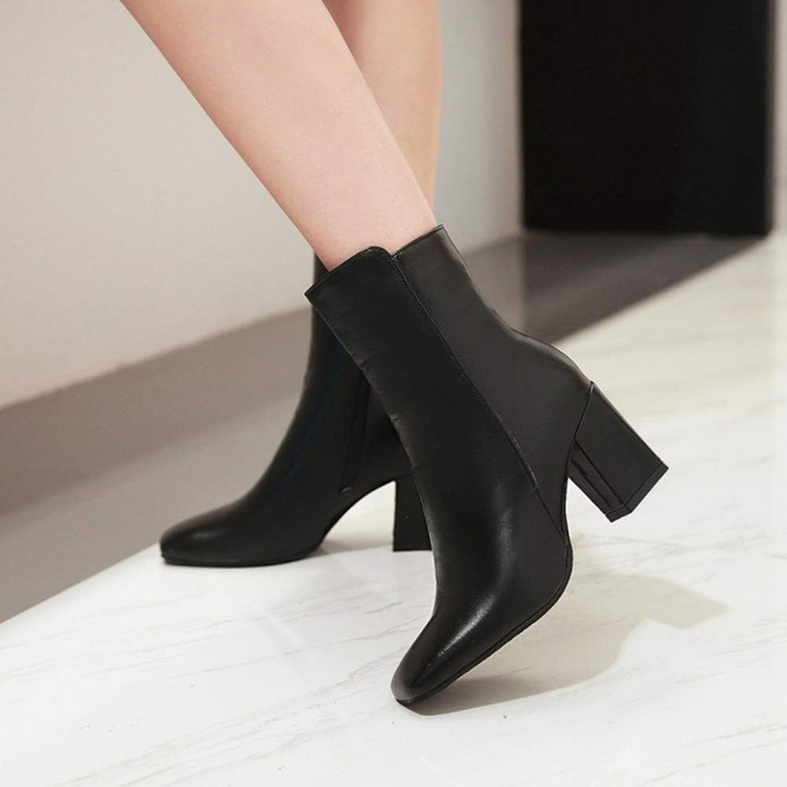 Black Women’s Sleek Side-Zip Ankle Boots with Comfortable Heel on the model