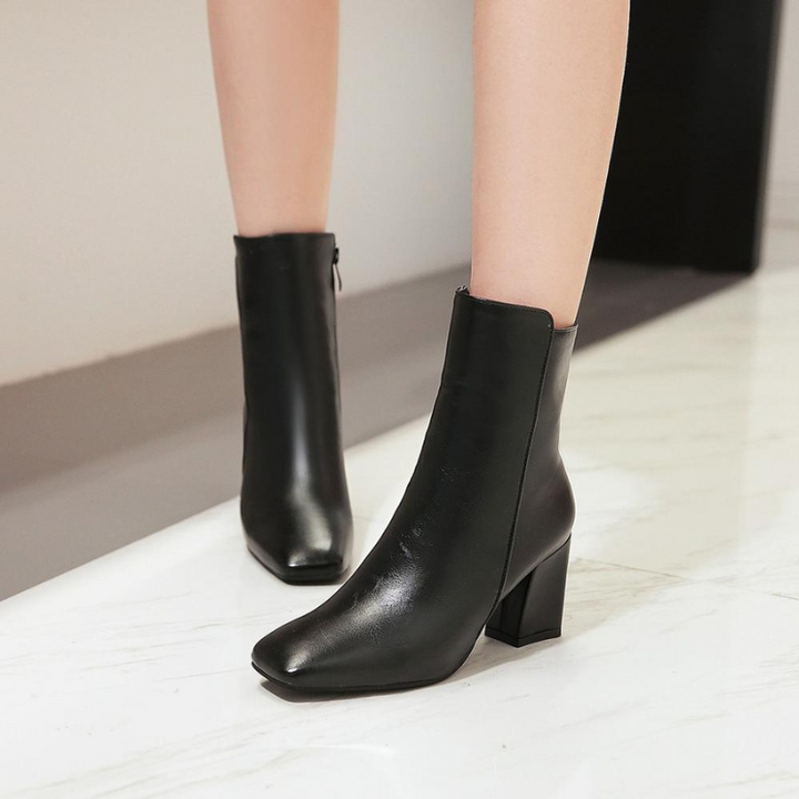 Black Women’s Sleek Side-Zip Ankle Boots with Comfortable Heel on the model