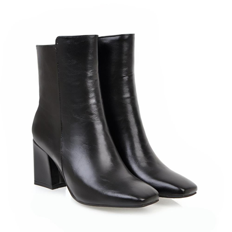 Black Women’s Sleek Side-Zip Ankle Boots with Comfortable Heel on the model