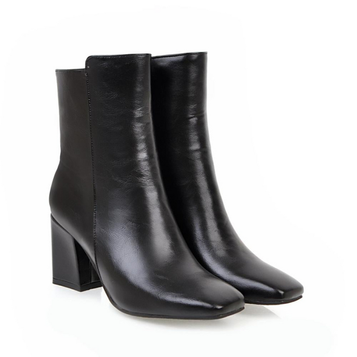 Black Women’s Sleek Side-Zip Ankle Boots with Comfortable Heel on the model