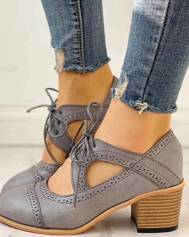 Gray Women’s PU Leather Brogue Heeled Boots on the model