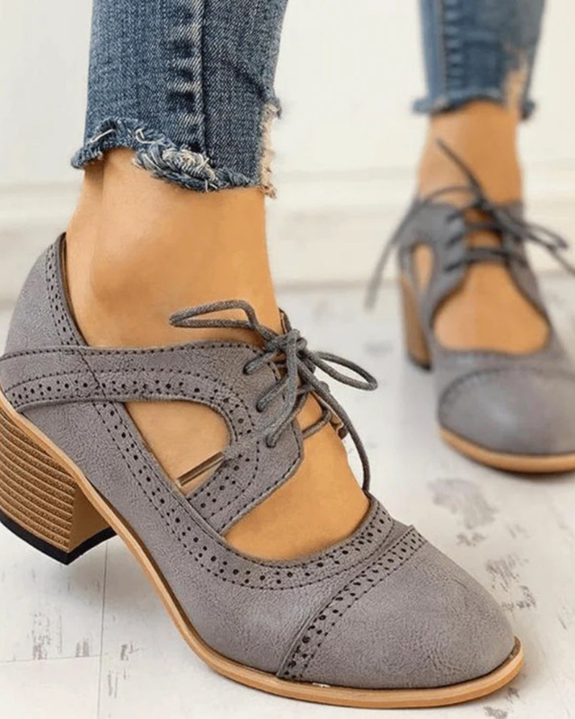 Gray Women’s PU Leather Brogue Heeled Boots on the model