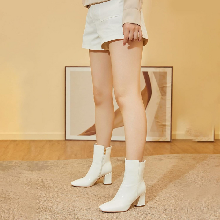 White Women’s Sleek Side-Zip Ankle Boots with Comfortable Heel on the model